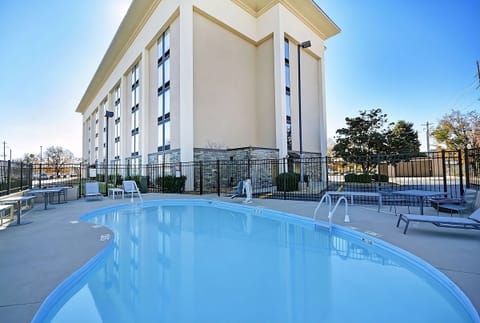 Dive into refreshing outdoor swims with sunlit loungers nearby.