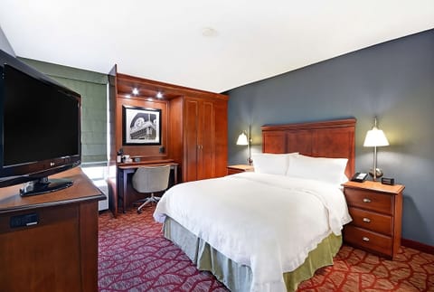 Unwind in a serene king room with desk and TV.