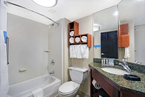 Freshen up with a bright vanity, towels, and tub shower.