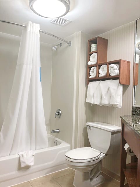 Enjoy a simple, clean bath space with fluffy towels ready.