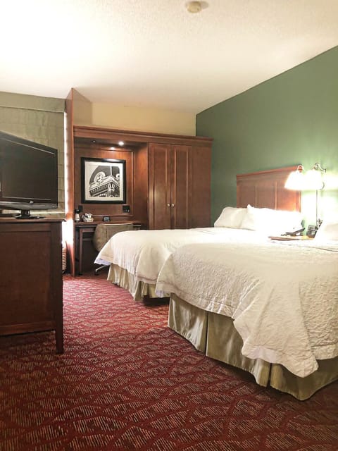 Recharge in a spacious room with classic wood furnishings.