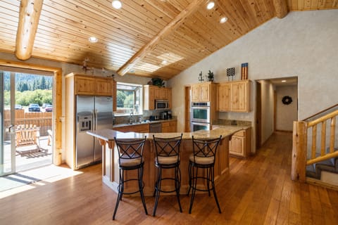 Fully equipped kitchen with barstool seating at the island counter.
