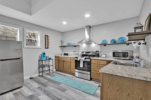 Exiting the bathroom and laundry area, looking into the kitchen