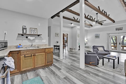 The doorway between the kitchen and living is the bedroom