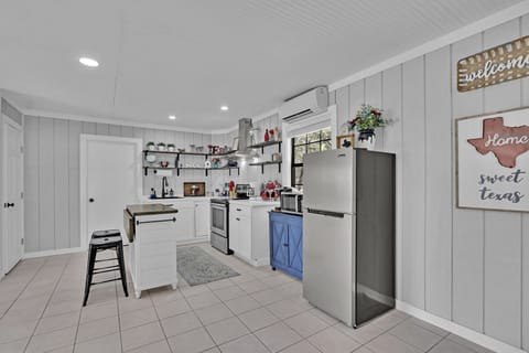 The kitchen is fully stocked with stainless steel appliances
