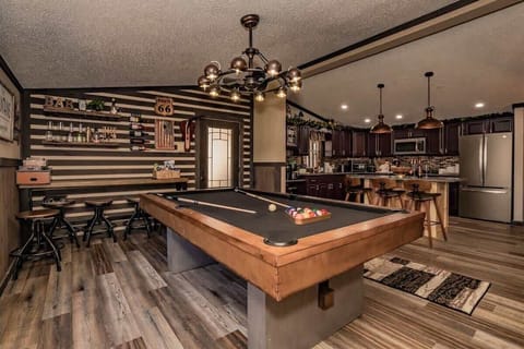Get ready to play pool or relax at the bar while watching your favorite sports on a 65" smart TV.