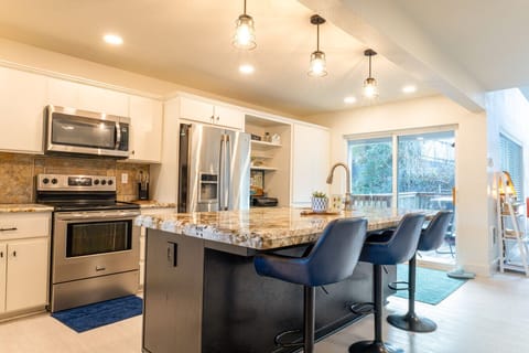 This open-concept view showcases the seamless flow from the kitchen to the dining area, perfect for entertaining during your stay.