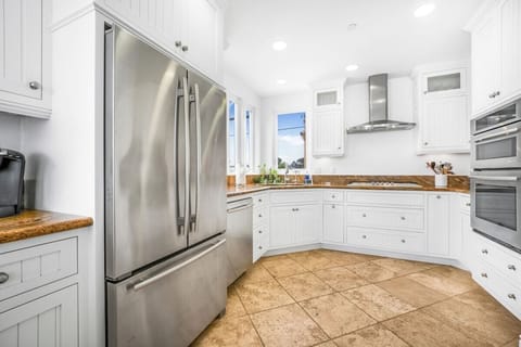 Designer kitchen with comfy leather bar stools.