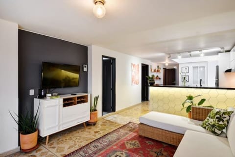 Smart TV with Netflix and comfy L-shaped couch.