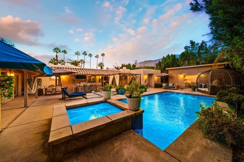 Stunning backyard oasis with a sparkling pool, spa, and stylish cabana