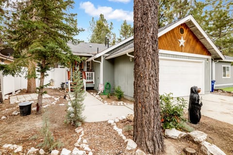 Welcoming cabin entry surrounded by towering pine trees, offering fresh mountain air and a peaceful forest setting—the perfect first impression for your Big Bear Lake getaway.