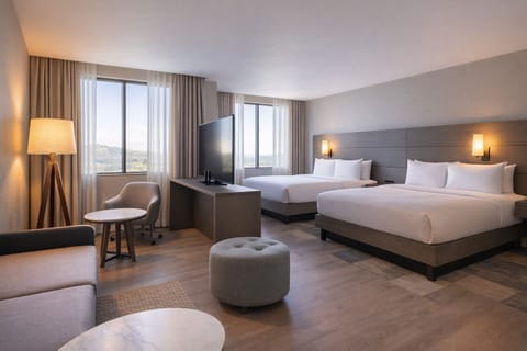 Relax in a spacious suite with lounge seating and daylight.