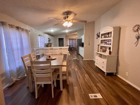 full size dining room with table that seats 6 and 4 bar stools