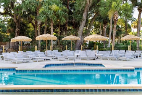 Lounge all afternoon with shaded chairs and calm turquoise water.