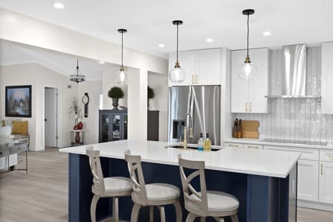 Expansive fully equipped kitchen with breakfast bar seating for up to three