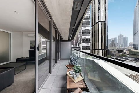 A balcony with a setting & city views.