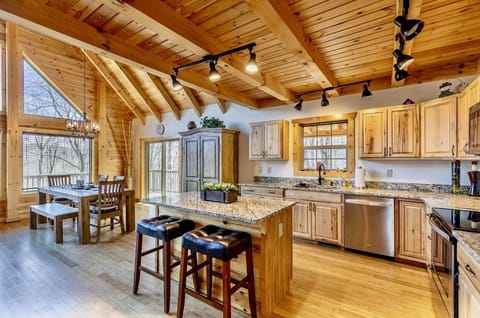 Fully stocked kitchen with granite countertops, refrigerator, dishwasher, microwave, an electrical oven