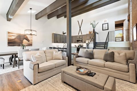 Cozy living room with open floor plan—seamlessly connected to the kitchen and dining area for easy gathering and relaxation!