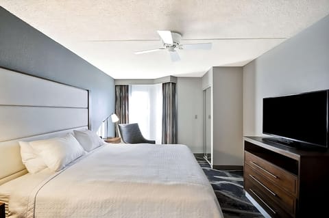 Unwind in crisp linens with TV and daylight views.