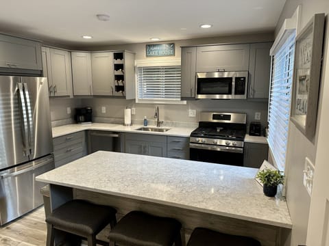 Brand new kitchen with quartz countertops with island seating for six