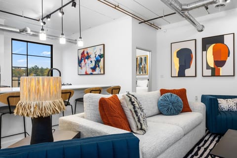 Gather in this inviting living space after a day of exploring, laughter echoing off the walls as the sun sets and the city lights begin to sparkle outside.