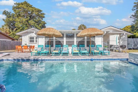 Resort style backyard - pool & spa, lounge chairs, tiki umbrellas, pool basketball, fire pit, bbq grill, surf board outdoor shower, detached bunk house, outdoor table seating, outdoor sectional.