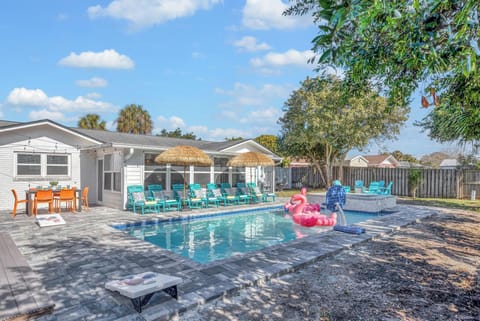 Resort style backyard - pool & spa, lounge chairs, tiki umbrellas, pool basketball, fire pit, bbq grill, surf board outdoor shower, detached bunk house, outdoor table seating, outdoor sectional.