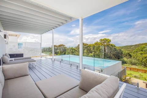 The downstairs living area opens out onto a spacious deck, where guests can kick back on the couch or sun lounger and enjoy a glass of wine at sunset.
