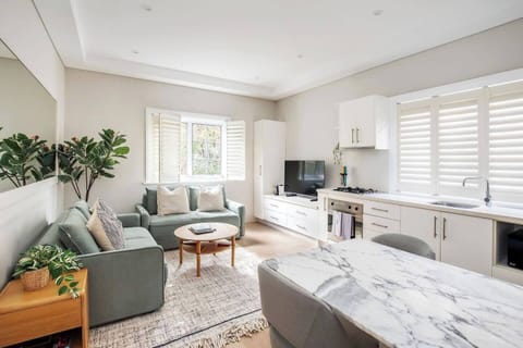 Experience seamless flow from the kitchen to the inviting open-plan dining and living area, basked in sunlight from north-facing windows. Chic shutters allow you to effortlessly adjust the natural light to your preference.