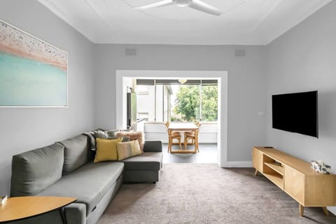 The living space highlights an L-shaped sofa and chaise where guests can settle in with a movie.
