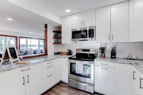 The kitchen has a wide open view of the living room w/ beautiful lake views.