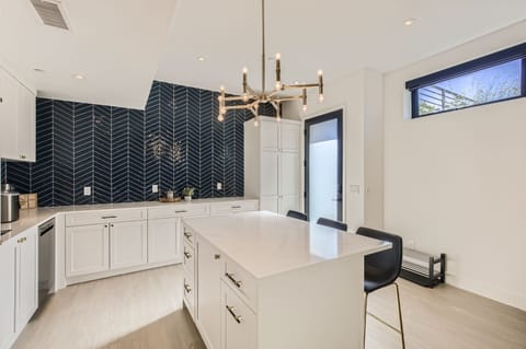 Large wet bar area with an island and bar stools.