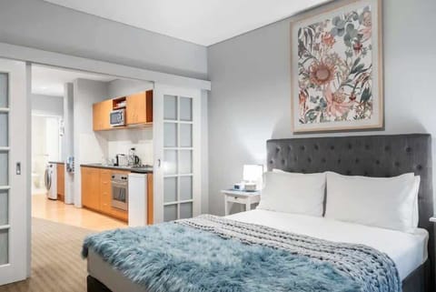 Bedroom with French doors to kitchen, living and bathroom