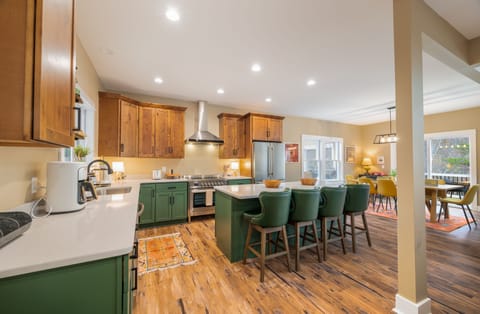 Designer decorated kitchen with high-end appliances, large eat-in island with Granite Counters