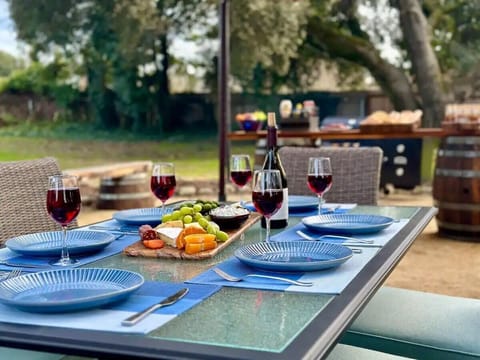 Enjoy a cozy wine and snack moment on the patio, surrounded by serene backyard views.