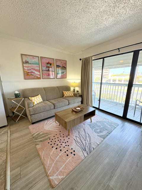 Comfortable couch with a view to the balcony and a coffee table for some family games