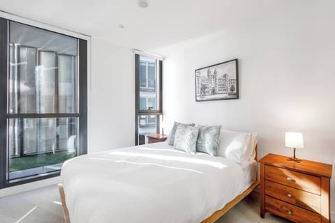The primary bedroom boasts a window that offers a delightful view of the balcony, filling the space with natural light. 
