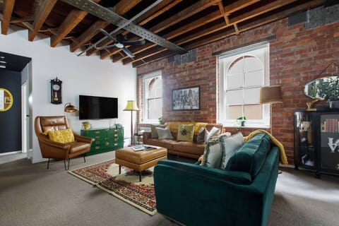 Kick back and relax within the living area with a flat-screen TV, plenty of seating, and a ceiling fan keeping the place comfortable.