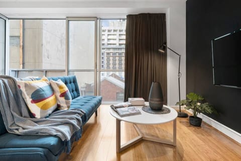Kick back and relax in the bright living room in front of a large screen TV. 