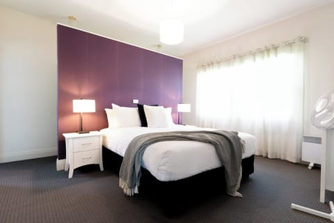Comfortable queen bed adorned with plush linen