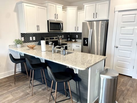 Fabulous Entertaining: Experience the Perfect Blend of Style and Functionality in our Kitchen, Boasting a Spacious Peninsula and Bar Sitting Area, Ideal for Effortless Socializing and Enjoying Culinary Delights in a Modern and Inviting Space.