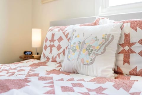 Snuggle up in this cozy queen bed with soft, plush bedding, the perfect spot to relax after a day of exploring Jonesborough.