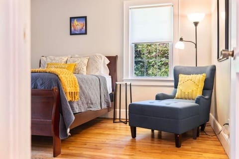 Cozy and inviting, this bedroom features a queen bed and a lounge chair, creating a perfect spot for rest and relaxation.