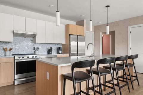 A fully equipped kitchen, stocked with coffee, tea, and condiments, along with a dining table to enjoy homemade meals.