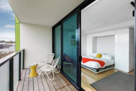 Sliding glass doors open from the studio out to the private balcony.
