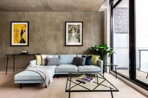 Concrete walls and ceilings complete the industrial vibe of the open-plan living area.