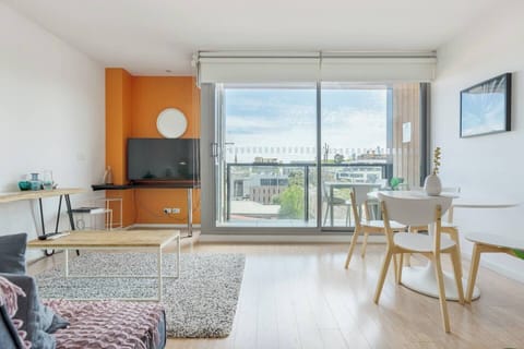 An open-plan layout is drenched in natural light and opens up to a private balcony with seating to enjoy the fresh air.