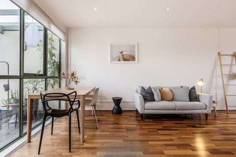 The living and dining area is open plan and flows to the balcony, filling the space with beautiful natural light.