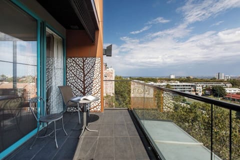 A private corner balcony offers spectacular views of the city and coast. 