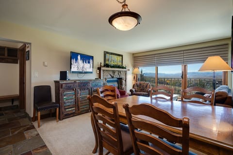Gather around this stunning dining table while enjoying sweeping mountain views through floor-to-ceiling windows.